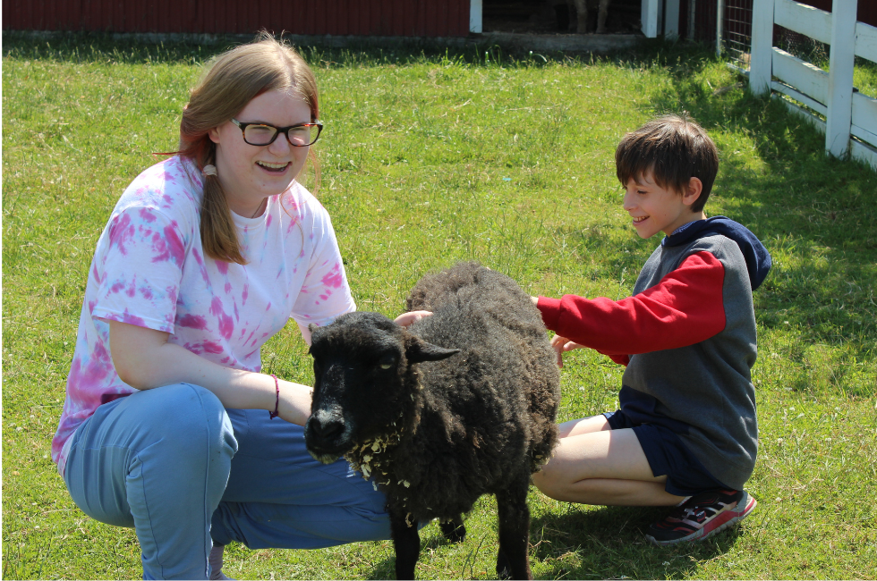 Mentor Charlotte and Mentee Ethan spend time socializing Bo Peep the sheet together while smiling.